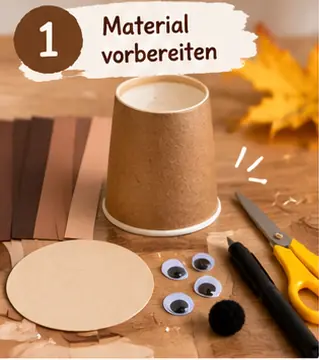 Schritt 1: Brauner Pappbecher, Papier, Gesichtskreis, Wackelaugen, Pompon, Schere und Stift liegen bereit